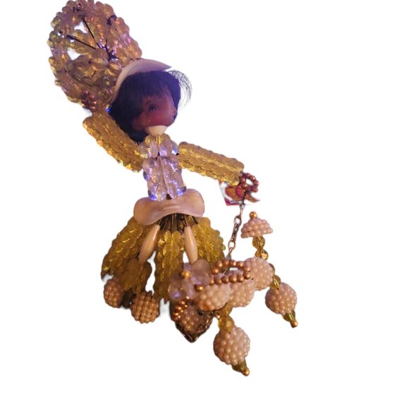 vintage handmade beaded woman with poddle